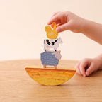 Farm animals balanced on the curved wooden hay piece