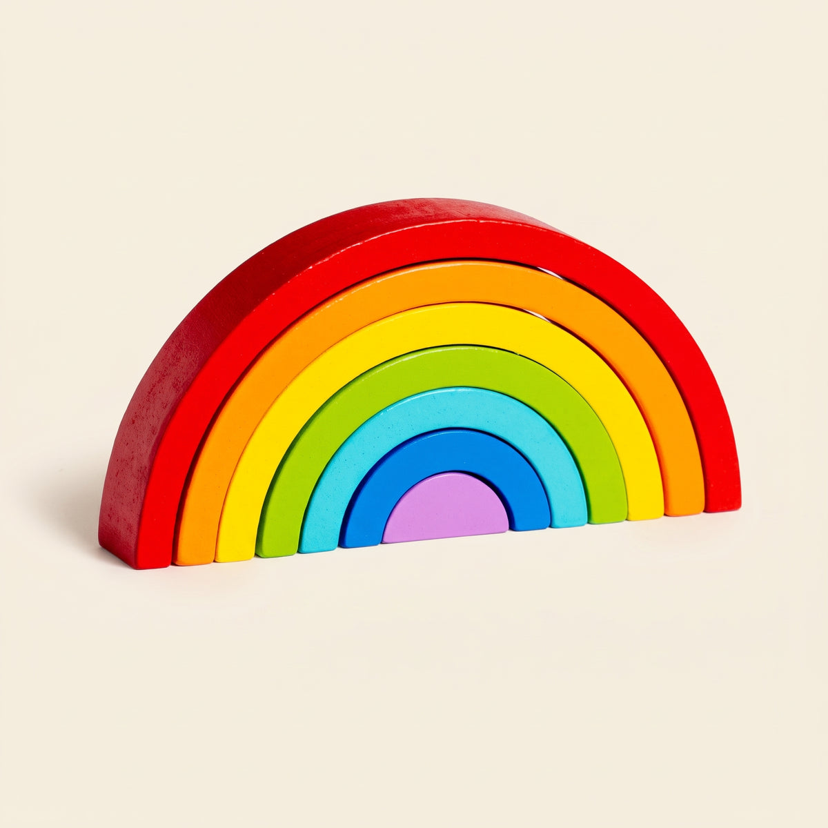 Classic wooden rainbow stacker on a cream background
