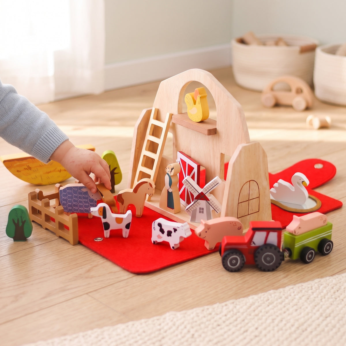 Toddler placing the wooden horse by the farm fence
