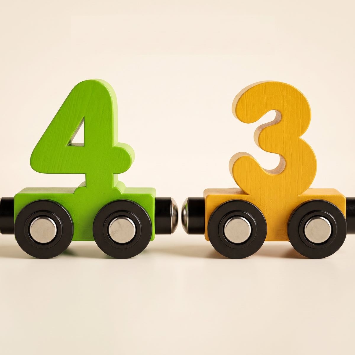 Close-up of the magnetic coupling between two wooden number wagons