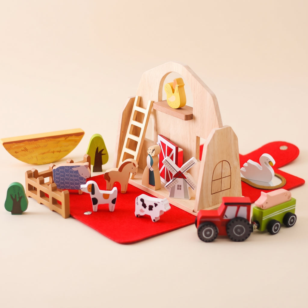 Wooden farm barn play set with animals, tractor and red felt mat
