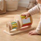 Child's hands turning the wooden spinning drum