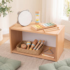 Wooden musical instruments arranged on a low Montessori shelf and in a woven basket