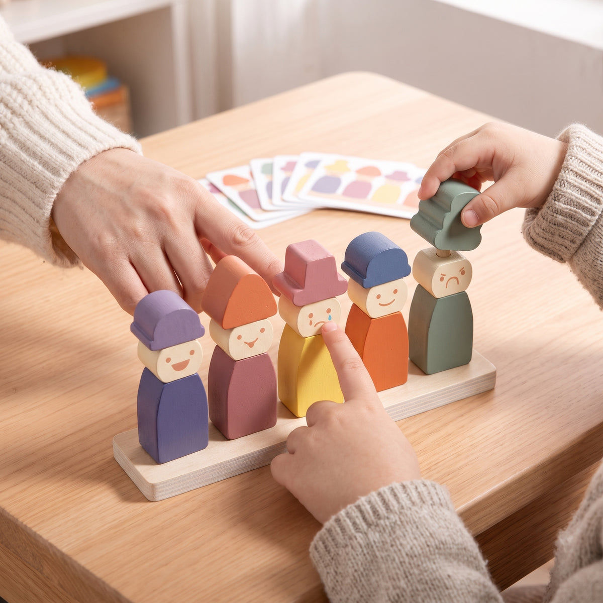 A parent and child talking about the feelings on the wooden peg dolls