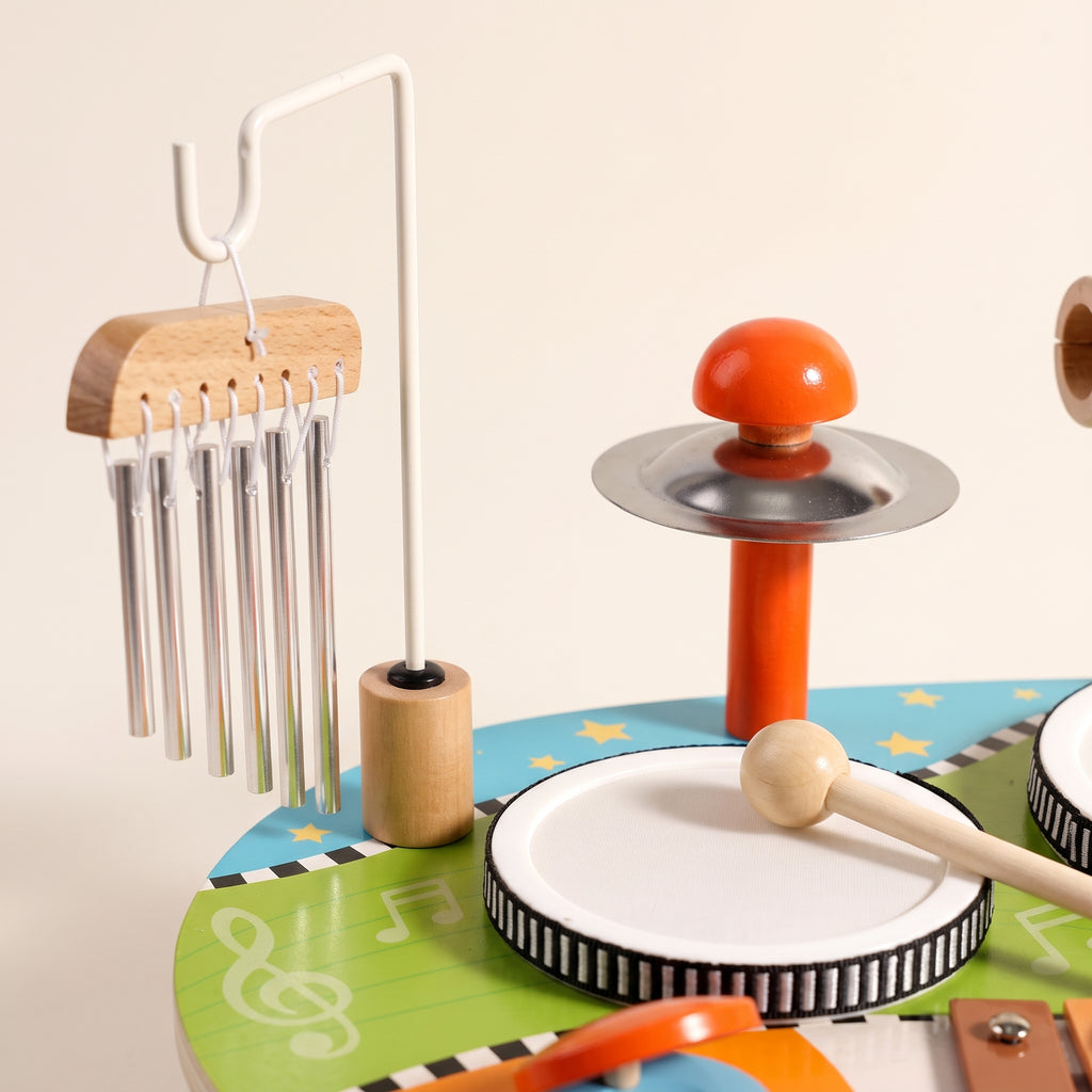 Close-up of the wind chimes and cymbal of the wooden music table