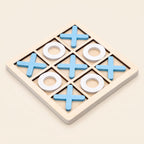 Wooden noughts and crosses board with blue crosses and white noughts