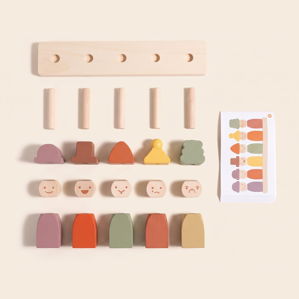 All the pieces of the wooden feelings peg dolls laid out: base, pegs, hats, faces, bodies and cards