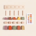 All the pieces of the wooden feelings peg dolls laid out: base, pegs, hats, faces, bodies and cards