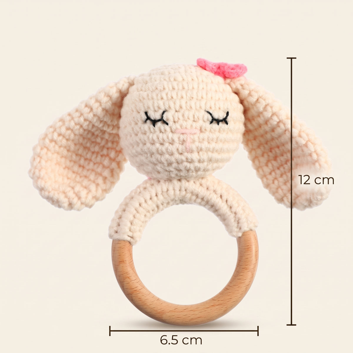 Crochet bunny rattle measuring 12 cm tall with a 6.5 cm wooden ring