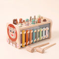 Wooden lion hammer bench with xylophone, hammers, mallets and fishing rod on a cream background