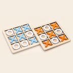 Two wooden noughts and crosses boards, one with blue crosses and one with orange crosses, on a cream background
