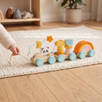 Toddler pulling the wooden train along by its rope