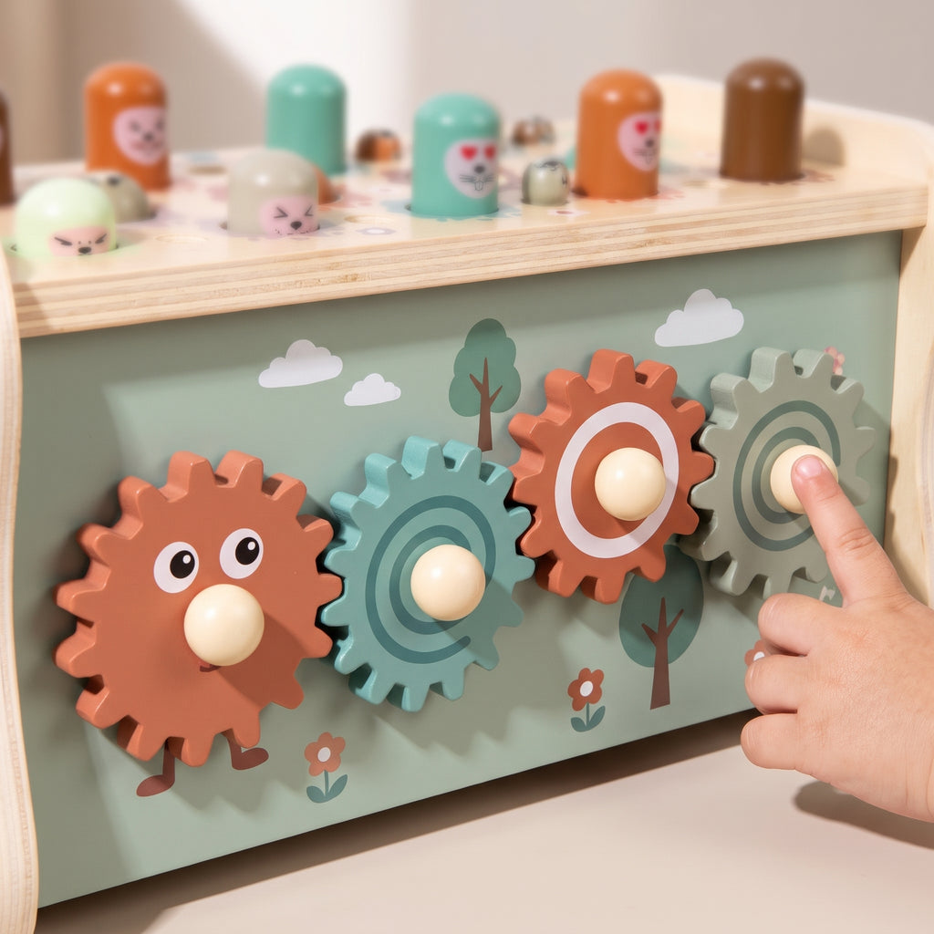 Close-up of a child's finger turning the wooden gears on the back of the bench