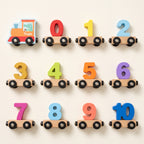All 12 pieces of the wooden number train laid out: the engine and wagons 0 to 10